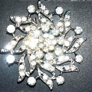 Silver brooch with rhinestones